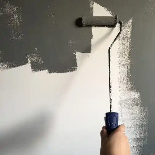 An experienced house painter at work